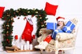Miss Santa in red hat holds blue present boxes Royalty Free Stock Photo