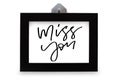 Miss you. Handwritten text. Modern calligraphy. Inspirational quote. Black photo frame. Isolated on white