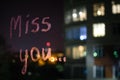 Miss you, inscription text by lipstick on the window glass in the night. Love concept. Royalty Free Stock Photo