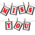 MISS YOU lettering on filmstrips hang on a leash - isolated on white background Royalty Free Stock Photo