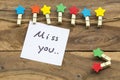 Miss you message card handwriting with colorful wooden star clips Royalty Free Stock Photo