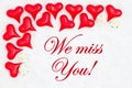 We miss you message with red hearts on white fabric