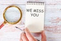 WE MISS YOU written on a blank sheet of a notebook Royalty Free Stock Photo