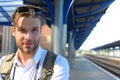 Missed train and travelling concept. Young man standing on platform Royalty Free Stock Photo
