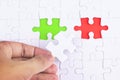 Missing jigsaw puzzle piece with green and red, business concept for completing the final puzzle piece. Royalty Free Stock Photo