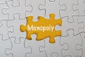 Missing jigsaw puzzle with text MONOPOLY isolated on a yellow background