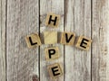 Missing Letter Puzzle Educational Word Game â HOPE and LOVE Crossword Concept on Rustic Table Royalty Free Stock Photo
