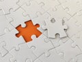 Missing piece of the puzzle, white puzzle pieces on orange background Royalty Free Stock Photo