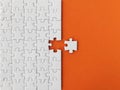 Missing piece of the puzzle, white puzzle pieces on orange background Royalty Free Stock Photo