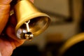 Mission bell in hand close up view