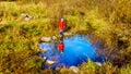 Little Girl looking at her reflection in the water of Silverdale Creek Wetlands, a Marsh and Bog on a nice fall day Royalty Free Stock Photo