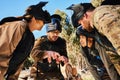 Mission, paintball or people in huddle planning strategy, teamwork or soldier training on war battlefield. Meeting