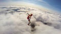 Mission. Parachutist performs an acrobatic trick in the air. Flying men make professional jump.