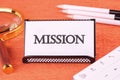 Mission text on a white business card on an orange background Royalty Free Stock Photo