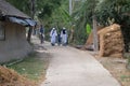 Missionaries of Charity - Mother Teresa nuns walk with child in Chunakhali, India