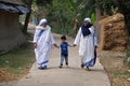 Missionaries of Charity - Mother Teresa nuns walk with child in Chunakhali, India Royalty Free Stock Photo