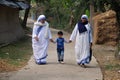 Missionaries of Charity - Mother Teresa nuns walk with child in Chunakhali, India