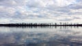 Mississippi Lake, blue sky with white clouds reflected in calm water, peninsula with sparse trees, autumn landscape Royalty Free Stock Photo