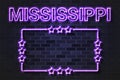 Mississippi US State glowing violet neon letters and starred frame on a black brick wall Royalty Free Stock Photo