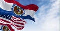 Missouri state flags waving with the national american flag on a clear day Royalty Free Stock Photo