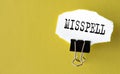MISSPELL - the word is printed on a white piece of paper on a yellow background Royalty Free Stock Photo