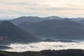 Mist filling a valley between some mountains and hills