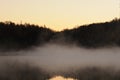 Mist over the lake, dusk over the lake, a very dense fog, dawn, blue sky over the lake, the morning comes, the forest Royalty Free Stock Photo