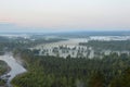 Mist over the river and the meadow, over the forest. Dawn in the summer.