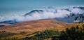 Mist over wheat fields and mountains in Tuscany Royalty Free Stock Photo