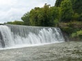 Mist rises from a Weir waterfall on the Root River in Lanesboro, Minnesota Royalty Free Stock Photo