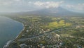 Mist at volcano eruption aerial. Clouds of haze over Mayon mount peak. Tropical green farmland Royalty Free Stock Photo