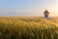 Mist on wheat field with chapel in Slovakia Tatras Royalty Free Stock Photo