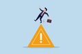 Mistake caution, business risk or problem warning, cautious businessman slip falling on exclamation symbol beware, careful caution