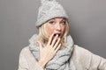 Mistake concept for stunned young blond winter woman Royalty Free Stock Photo