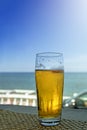 Misted glass of beer in the beach bar on the background of the sea landscape. Sunny hot day, afternoon. Royalty Free Stock Photo