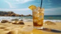 Misted glass of a cold cocktail with ice is standing on the sand near the edge of the sea. Beach holidays, vacations, summer Royalty Free Stock Photo