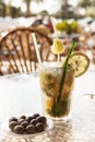 Misted glass of mojito with olives on a glass table Royalty Free Stock Photo
