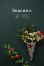 Mistletoe, holly and text seasons greetings