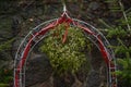 Mistletoe twigs on a metal arch in front of a stone wall, according to traditional Christmas custom you may kiss anybody Royalty Free Stock Photo