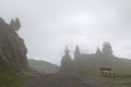 Misty Alpine mood with a red bench