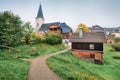 Misty autumn cityscape of Altaussee town with Heiliger Agidius church on background, district of Liezen in Styria, Austria. Beauty