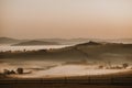 Misty autumn landscape with the herd of cows grazing on the pasture in the valley Royalty Free Stock Photo