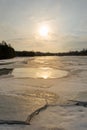 Misty calm evening on the forest lake is illuminated by the colors of sunset, melting ice, reflection in the water mirror Royalty Free Stock Photo