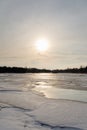 Misty calm evening on the forest lake is illuminated by the colors of sunset, melting ice, reflection in the water mirror Royalty Free Stock Photo