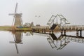 Misty and calm windmill bridge Royalty Free Stock Photo