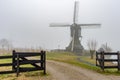 Misty and calm windmill sunrise Royalty Free Stock Photo