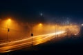 Misty city night lights twinkle, roads wind, and cars traverse Royalty Free Stock Photo