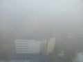 Misty cityscape in heavy fog weather. Aerial view
