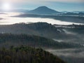 Misty dark forest landscape in the morning sunrise.  Heavy fog and forest tree view on top. Royalty Free Stock Photo