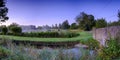 Misty dawn light on Stoke Charity village pond and St Michael`s Church, Hampshire, UK Royalty Free Stock Photo